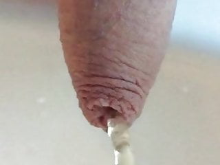 Uncut cock pees through foreskin in slo mo