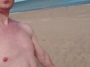 Dad walking alone on beach naked