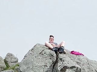 Zoey masturbating in public high up on a rock in the harbor