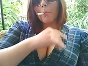 Heavy chested brunette smoking