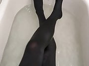 Playing in the tub in pantyhose. 