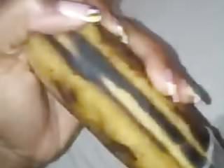 Ebony girl masturbates with a banana