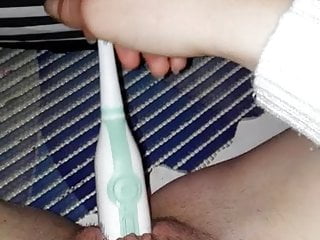 Girl mastubating with toothbrush